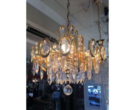 A six light gold-plated and crystal prism chandelier, consists of oval hoops and crystal droplets throughout, a gold-plated a