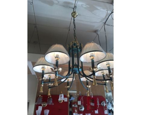 An eight-light verdigris and gold-plated chandelier with eight cream coolie shades with a verdigris and gold trim, the chande