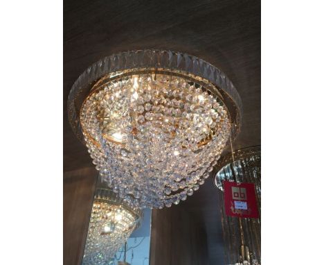 A four light gold plated and crystal flush ceiling light, crystal prisms surround the circular outer frame and crystal beads 