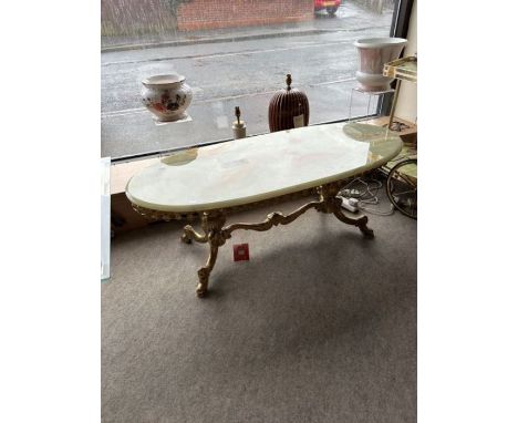 Three genuine green onyx tables with ornate brass bases; an oval onyx table with sturdy legs and intricate design around the 