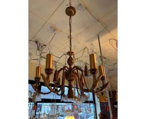 A gilt six-arm chandelier with a pineapple design to the central column, hanging tassels throughout, comes with a height adju