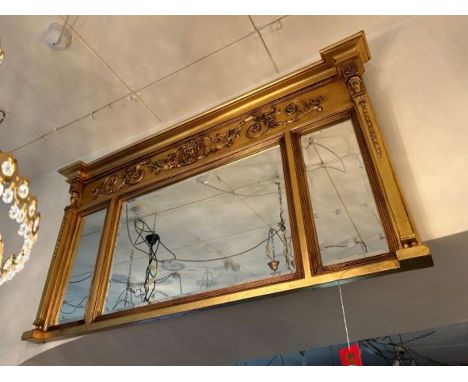 A rectangular gilt over mantel mirror consisting of one large mirror to the centre and two smaller mirrors either side, has a