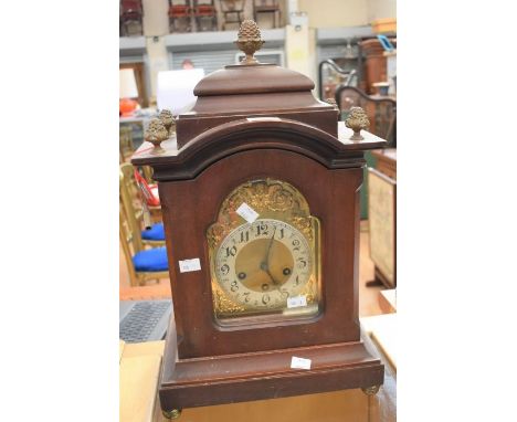 A large Victorian mahogany eight day mantle clock with Westminster chime, Arabic numerals, gilt detail with cherubs head arou