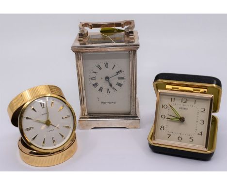 A Mappin and Webb silver-plated carriage clock, approx 11.5cm; a Seiko travel alarm clock; and a Europa travel alarm clock (3