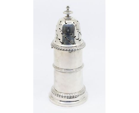 A late Victorian silver large caster, cylindrical reminiscent of a lighthouse shape, the domed cover with pierced decoration,