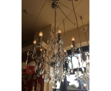 An eight-light chrome and crystal chandelier with clear glass centre column, crystal droplets throughout, adjustable chrome c
