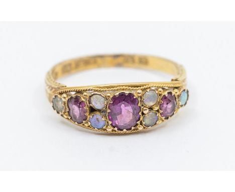 A Victorian amethyst and opal 15ct gold ring, comprising three oval amethysts within round cabochon opals accents, boat style