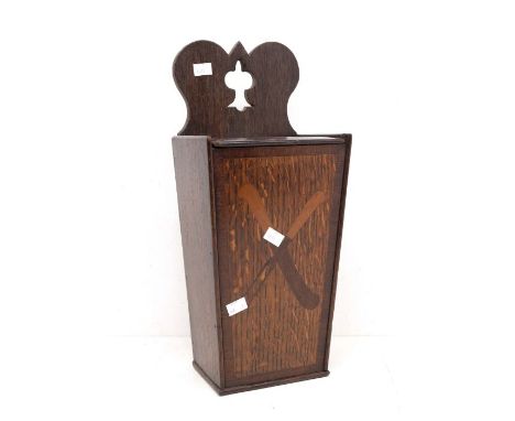 An 18th Century oak oval hanging candle box / cutlery box with knife and fork inlay to front and sliding top lid with finger 