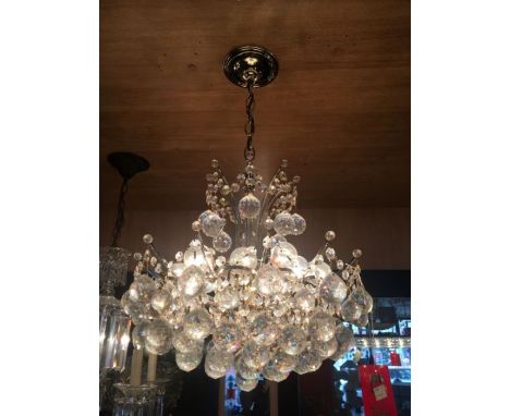 A genuine Swarovski Austrian Strass 12 light crystal chandelier with brass plated frame and weighted crystal balls. The frame