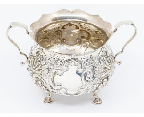 An Edward VII silver two handled sucrier embossed floral leafage scrolls, on hoof feet, London 1902, maker Goldsmiths &amp; S