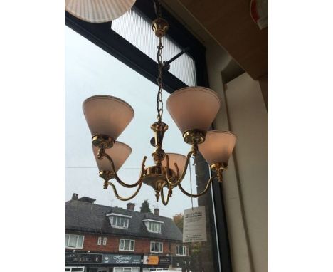 A five-arm gold finish chandelier, complete with white cone shaped glass shades, 5 x small bayonet golf bulbs, LED compatible