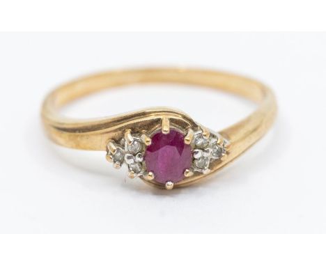 A ruby and diamond set 9ct gold dress ring, comprising an oval cut ruby within diamond accents, size S1/2, total gross weight