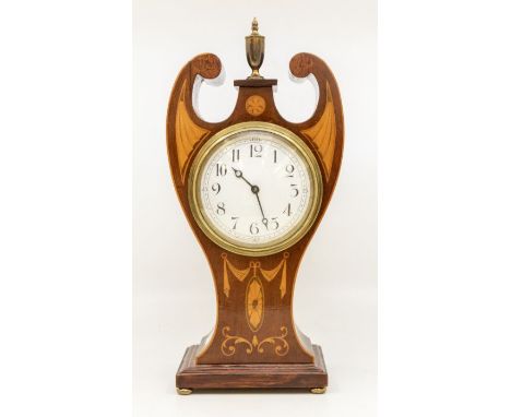 An Edwardian style inlaid mahogany mantle clock, white dial with arabic numerals, the case with swan neck pediments central b