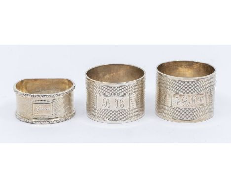 Three various 20th Century silver engine turned napkin rings, various dates and makers, approx 4.90 ozt (152.3 grams)&nbsp;
