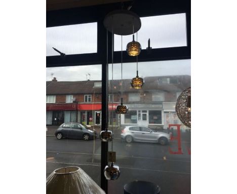 A five tier LED chrome pendant with adjustable height, consists of smoked glass shades which appear translucent when switched