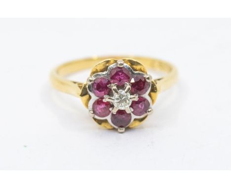 A ruby and diamond 18ct gold flower cluster ring, comprising round cut rubies with a central diamond, setting approx 10mm, si