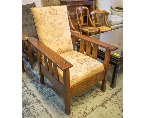 RECLINING ARMCHAIR, Arts and Crafts design oak framed with an adjustable back and a foliate patterned back and seat cushion, 