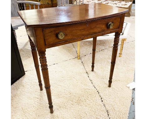 BOWFRONT WRITING TABLE, Regency mahogany with a single frieze drawer on ring turned supports, 75cm W x 80cm H x 44cm D. (with