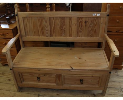 A modern pine bench with two drawer storage below the seat