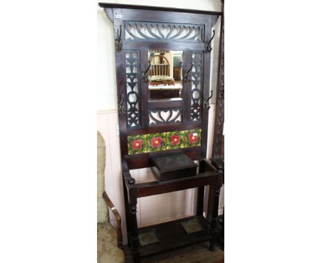 A mahogany hallstand with carved fretwork and tile back decoration