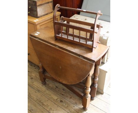 A flap leaf oval gate leg table and magazine rack