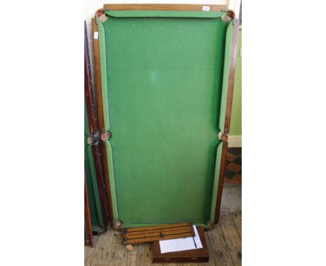 A vintage billiards table, score board and accessories