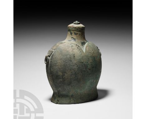 Han Dynasty, 206 B.C.-220 A.D. A copper-alloy pilgrim's flask with 'heart-shaped' moulding to both faces, splayed base, narro