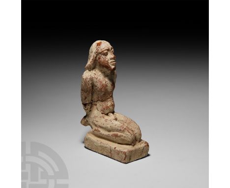 1st millennium B.C. A ceramic figure modelled in the round as a naked captive kneeling, hands bound and crossed, naturalistic