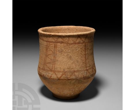 13th-12th century B.C. A ceramic carinated vessel with everted rim and shallow foot, ochre-coloured painted geometric motifs.