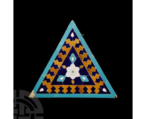 14th-15th century A.D. A triangular glazed ceramic tile with central floral motif; mounted on a custom-made display stand.  4