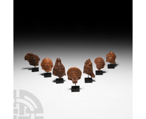 1st century B.C.-2nd century A.D. A group of votive terracotta figure heads comprising: two heads of the divine child Harpocr