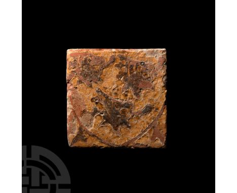 15th century A.D. A glazed ceramic floor tile decorated with three crowned lion heads with protruding tongues and large eyes,
