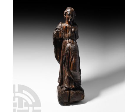 16th century A.D. A carved limewood figure of female, wearing a floor-length robe gathered at the waist and with a square nec