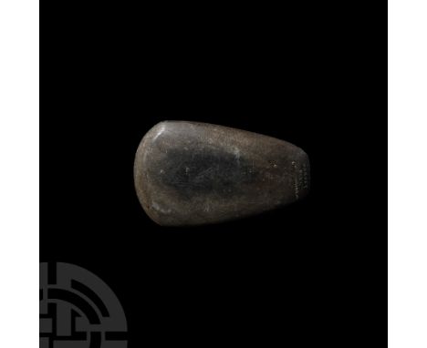 Neolithic, 4th-3rd millennium B.C. A polished greenstone hand axe head with lentoid-section body and D-shaped cutting edge, l