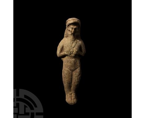 3rd-2nd millennium B.C. A ceramic fertility goddess figure modelled in the half-round with hands clasping breasts, wearing a 