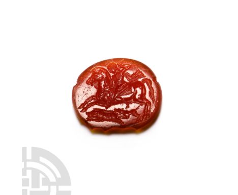 2nd-4th century A.D. An oval-shaped carnelian intaglio with hunting scene composed of an armoured and mounted horseman, Alexa