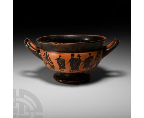 5th century B.C. A substantial ceramic black ware kylix with carinated profile and flared rim, short stem above a broad base 