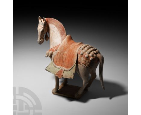 Northern Wei Dynasty, 386-534 A.D. A ceramic horse modelled in the round standing on an integral base, neck stretched upwards