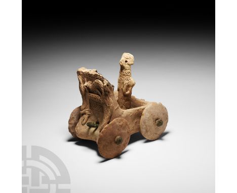 4th-3rd millennium B.C. A ceramic idol standing in a carriage or wagon, raised stylised animals in relief to the outer face o