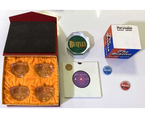 Beatles collectables to include; a boxed set of four cut glass apple paperweights, a pad of Beatles 1962-1966 / 1967-1970 not