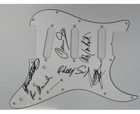 A plain white guitar scratchplate bearing signatures in black marker pen by members of Scorpions inc Rudolf Schenker, Paweł M