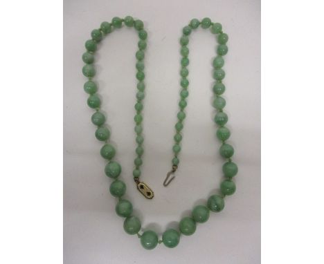 A green jade graduated bead necklace with a yellow metal clasp, stamped 14k, 21"l, overall 
