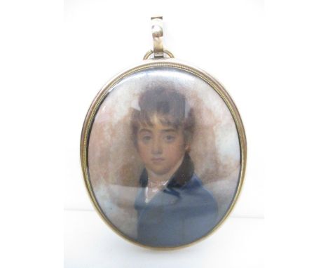 Attributed to William Wood - a portrait miniature of a boy wearing a blue jacket and a long lock of hair, held together with 