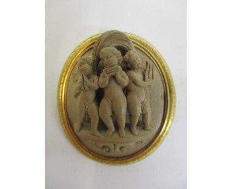 A Victorian 15ct gold set cameo lava brooch, of oval form carved in relief with three cherubs, playing musical instruments, o