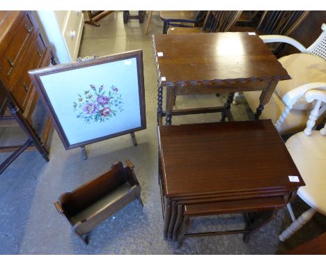 An oak barleytwist occasional table, mahogany nest of quartetto tables, oak paper rack and fire screen