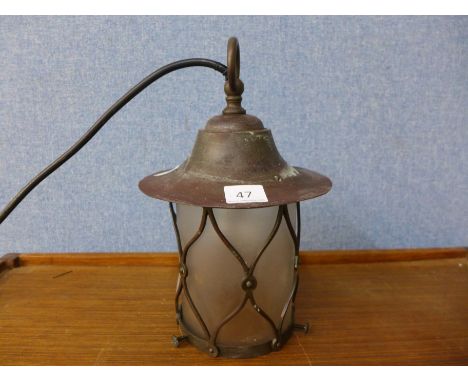 A copper and brass lantern light, with frosted glass shade