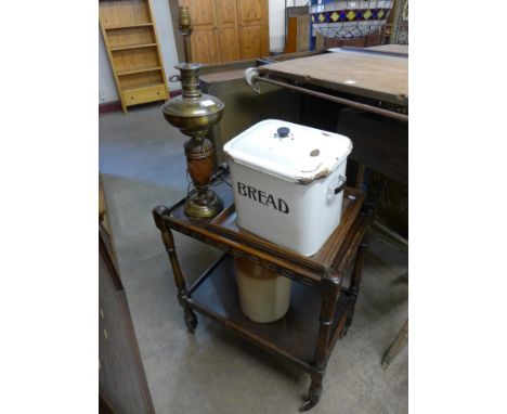 An enamelled bread bin, stoneware flagon, brass lamp, Indian carved tray and an oak trolley