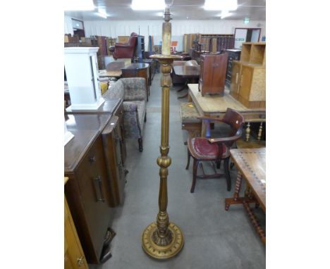 A gilt standard lamp