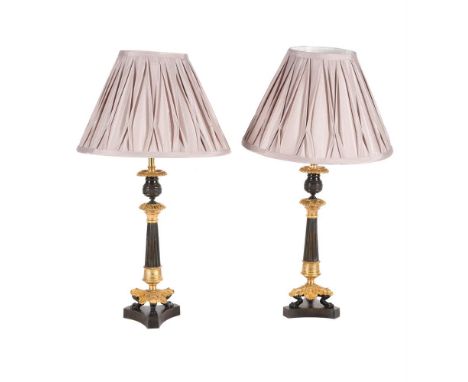 A PAIR OF GILT AND PATINATED METAL TRIFORM CANDLESTICKS  SECOND HALF 19TH CENTURY AND LATER CONVERTED TO ELECTRICITY  With a 