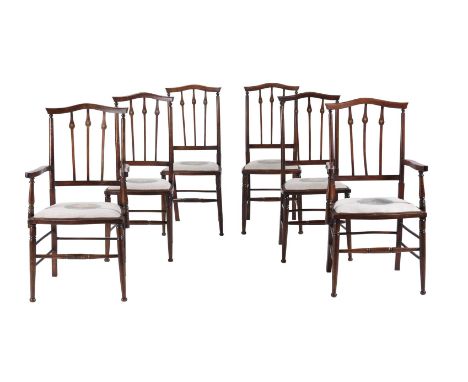 A SET OF SIX ART NOUVEAU DINING CHAIRS  CIRCA 1900 To include a pair of armchairs, each decorated with a motif to the top rai